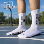 Athlete wearing white custom basketball socks on an outdoor court