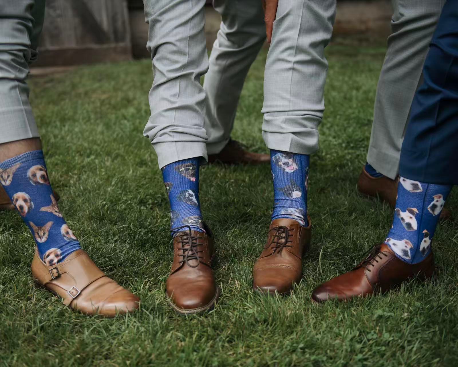 Groomsmen wearing blue printed logo socks with custom pet photos during an outdoor wedding event.