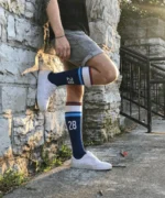 Athlete wearing custom number 28 over the calf athletic socks outdoors