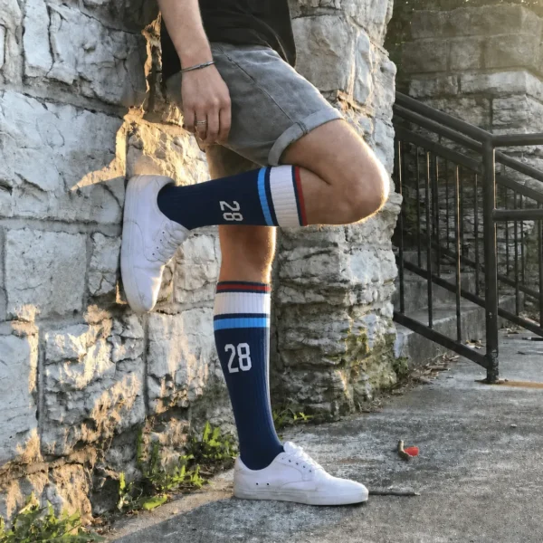 Athlete wearing custom number 28 over the calf athletic socks outdoors