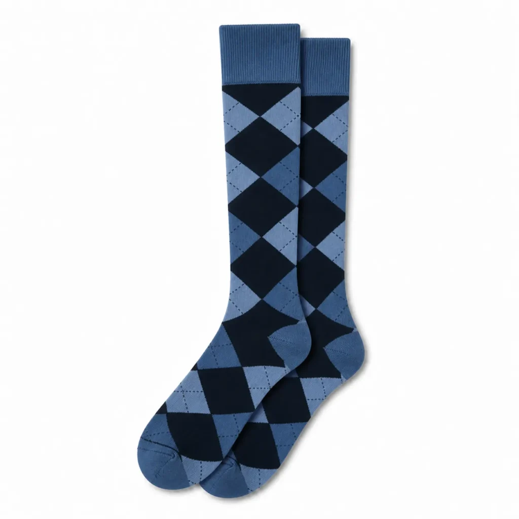 Pair of blue argyle custom over the calf dress socks on a white background.