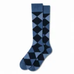 Pair of blue argyle custom over the calf dress socks on a white background.