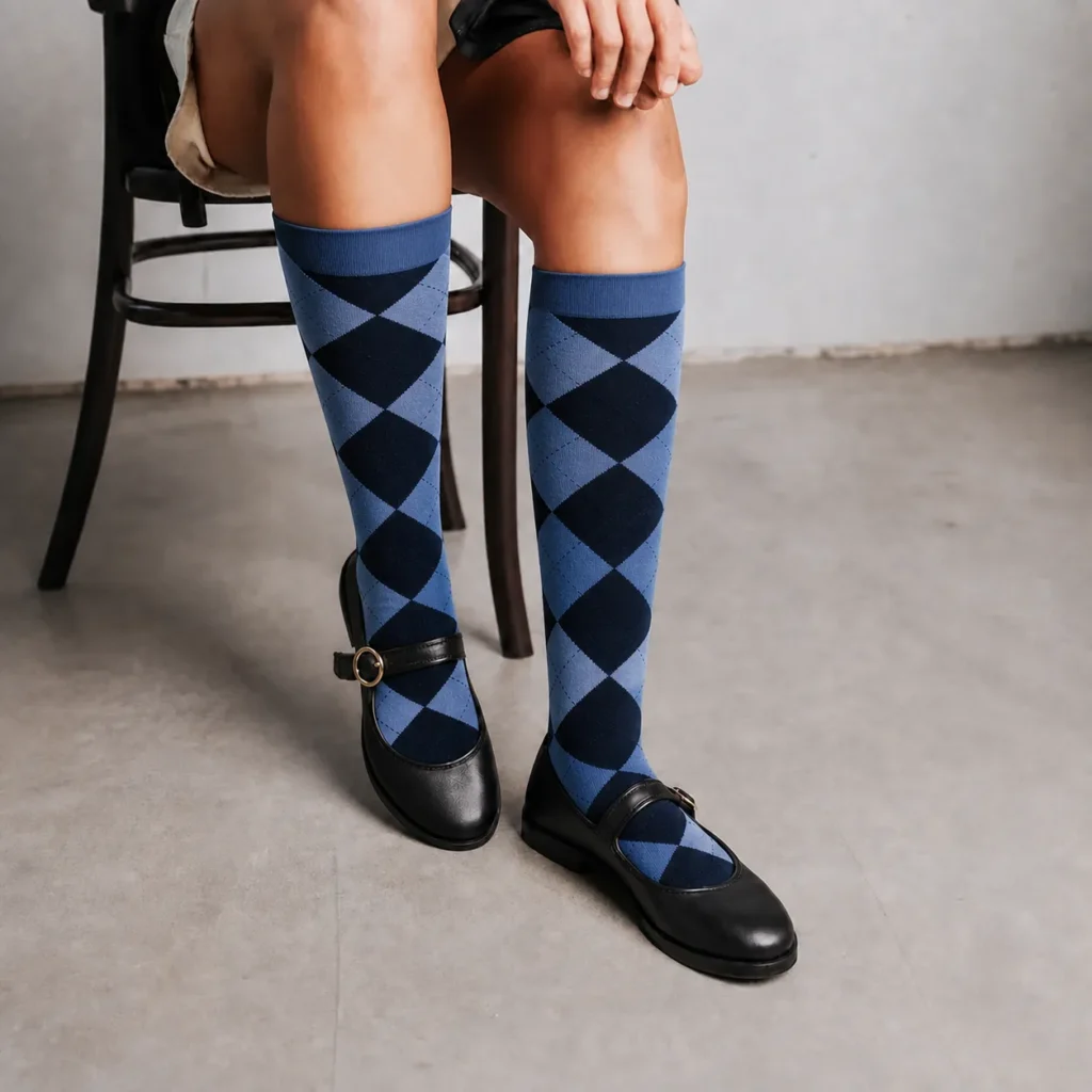 Blue argyle over the calf dress socks worn with black Mary Jane shoes.