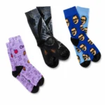 Three pairs of custom printed socks with purple doodle, dark photo, and blue face-print designs on a white background.