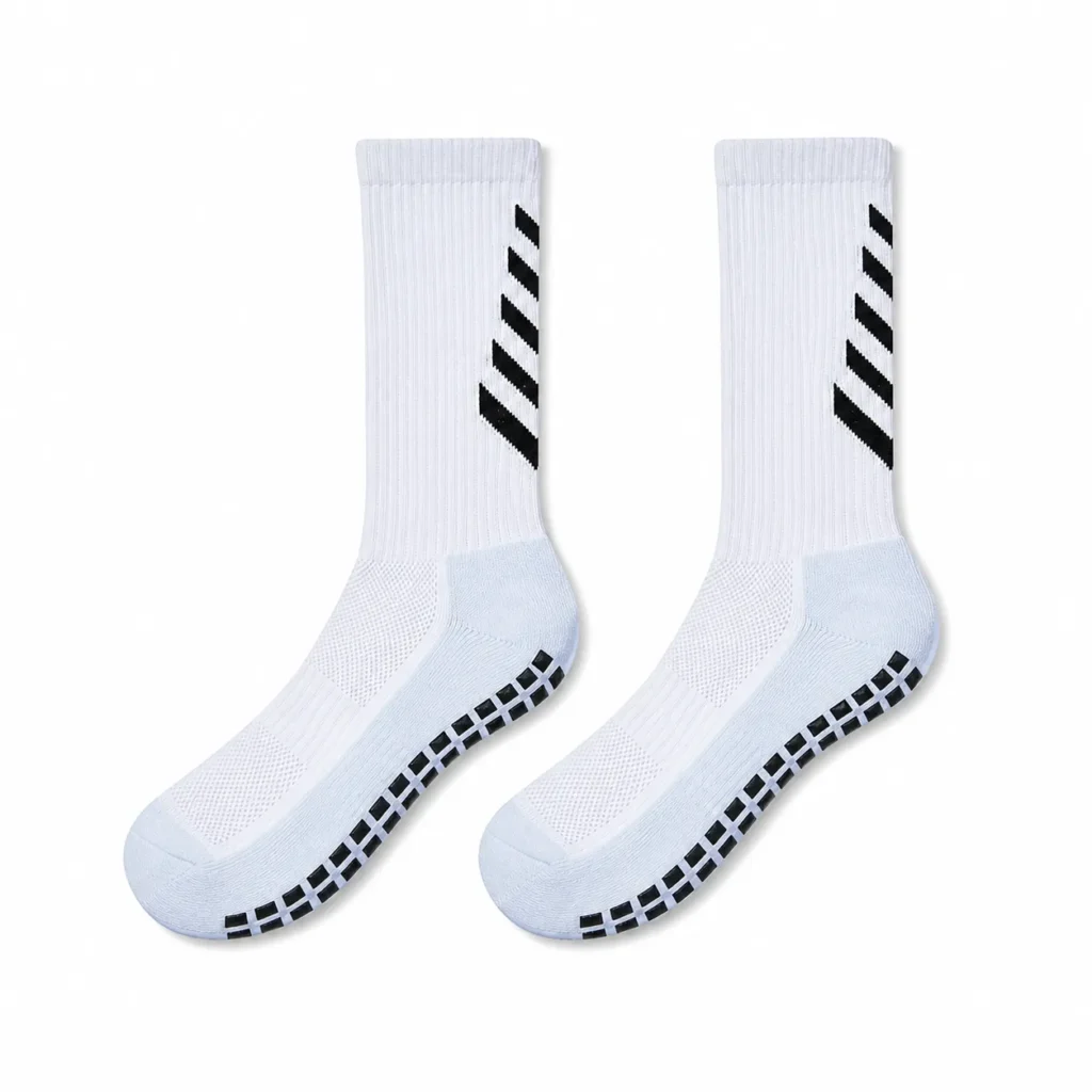 Pair of white soccer grip socks with black chevron leg details and black anti-slip sole pads.