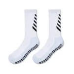 Pair of white soccer grip socks with black chevron leg details and black anti-slip sole pads.