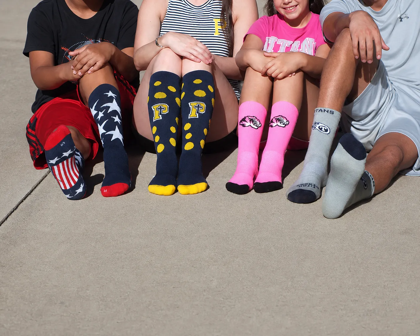 Group of people wearing colorful custom knitted logo socks with different woven patterns and designs.