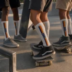 Skateboard team wearing white custom knee high athletic socks at an outdoor skatepark