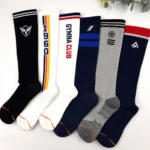 Six custom knee high athletic socks with logo, team name and stripe designs