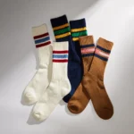 Three pairs of custom over the calf athletic socks in different colors and striped designs