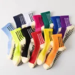 Colorful soccer grip socks in multiple colors with visible anti-slip sole pads.